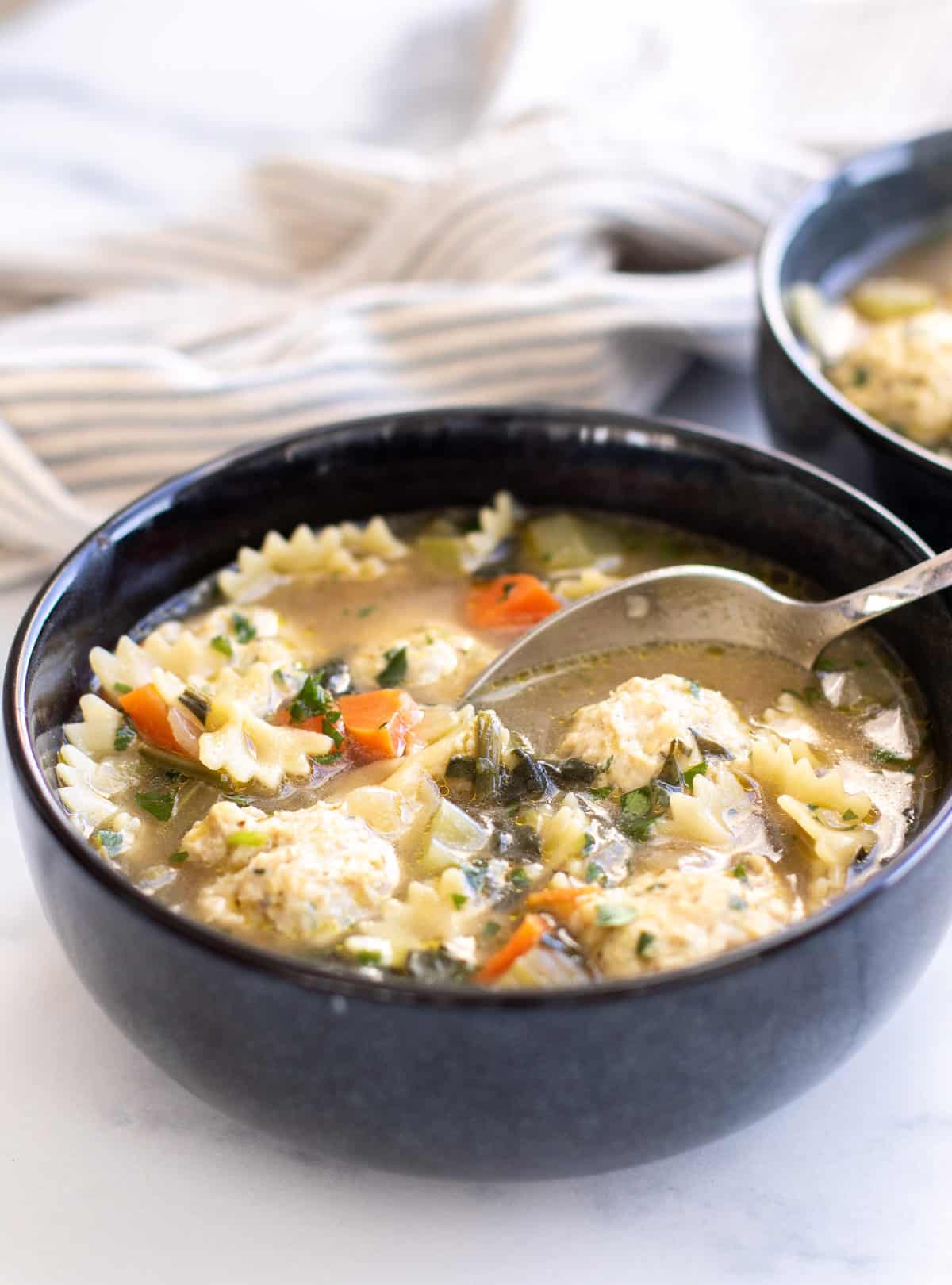 a bowl of soup with a spoon.