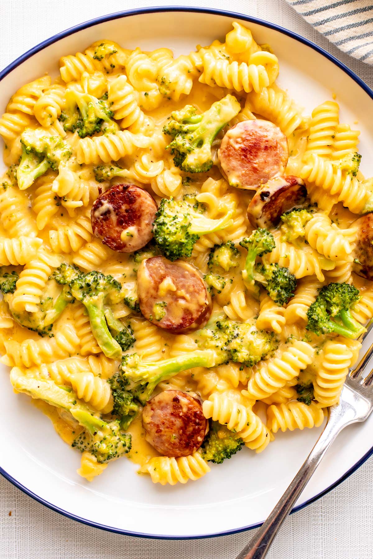 a plate of pasta with kielbasa