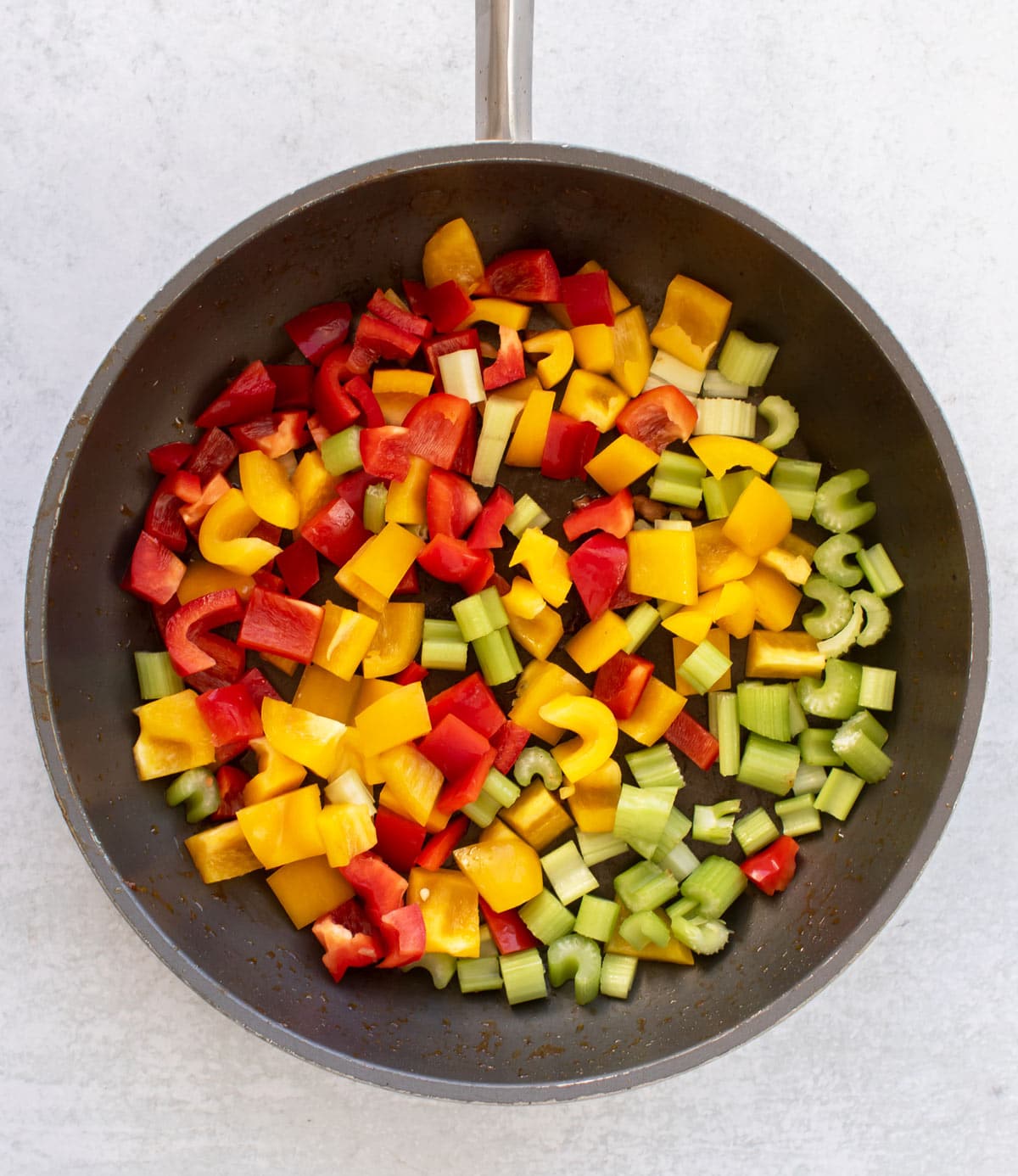 the peppers and celery in the pan.