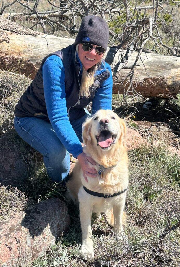 a golden retriever sitting in front of his employee.