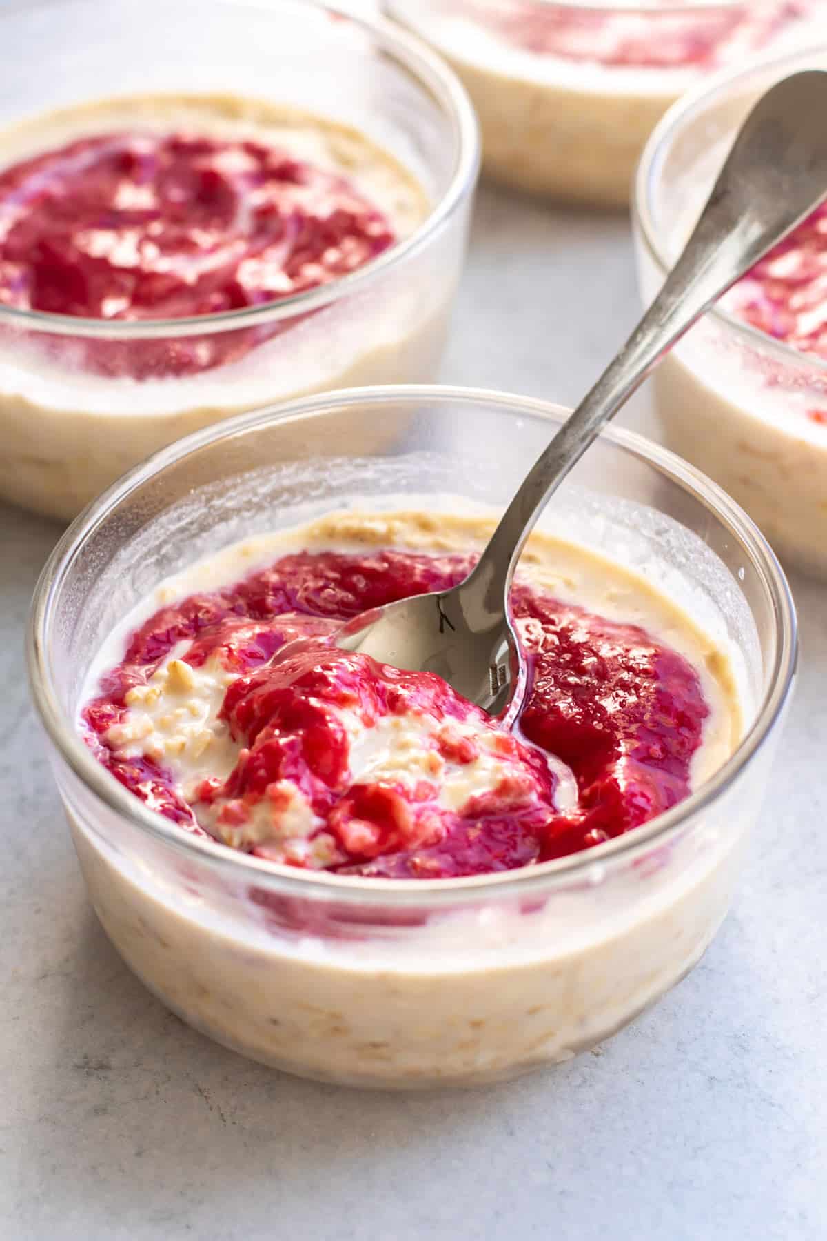 a bowl of peanut butter oats with raspberry sauce.