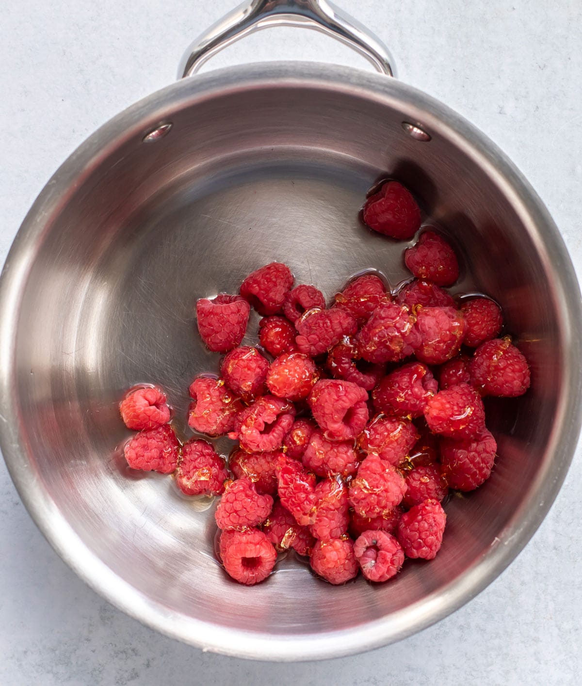 the raspberries, honey, and water in a pan.